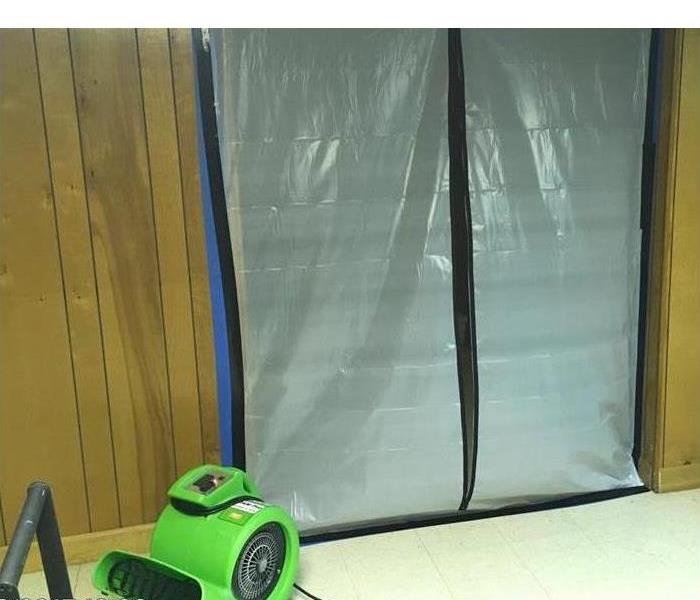 Air mover and plastic barrier in a wall